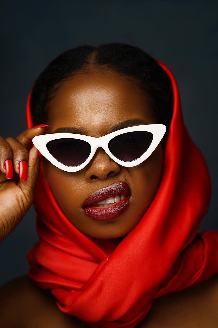 portrait of a young woman wearing a red headscarf and sunglasses