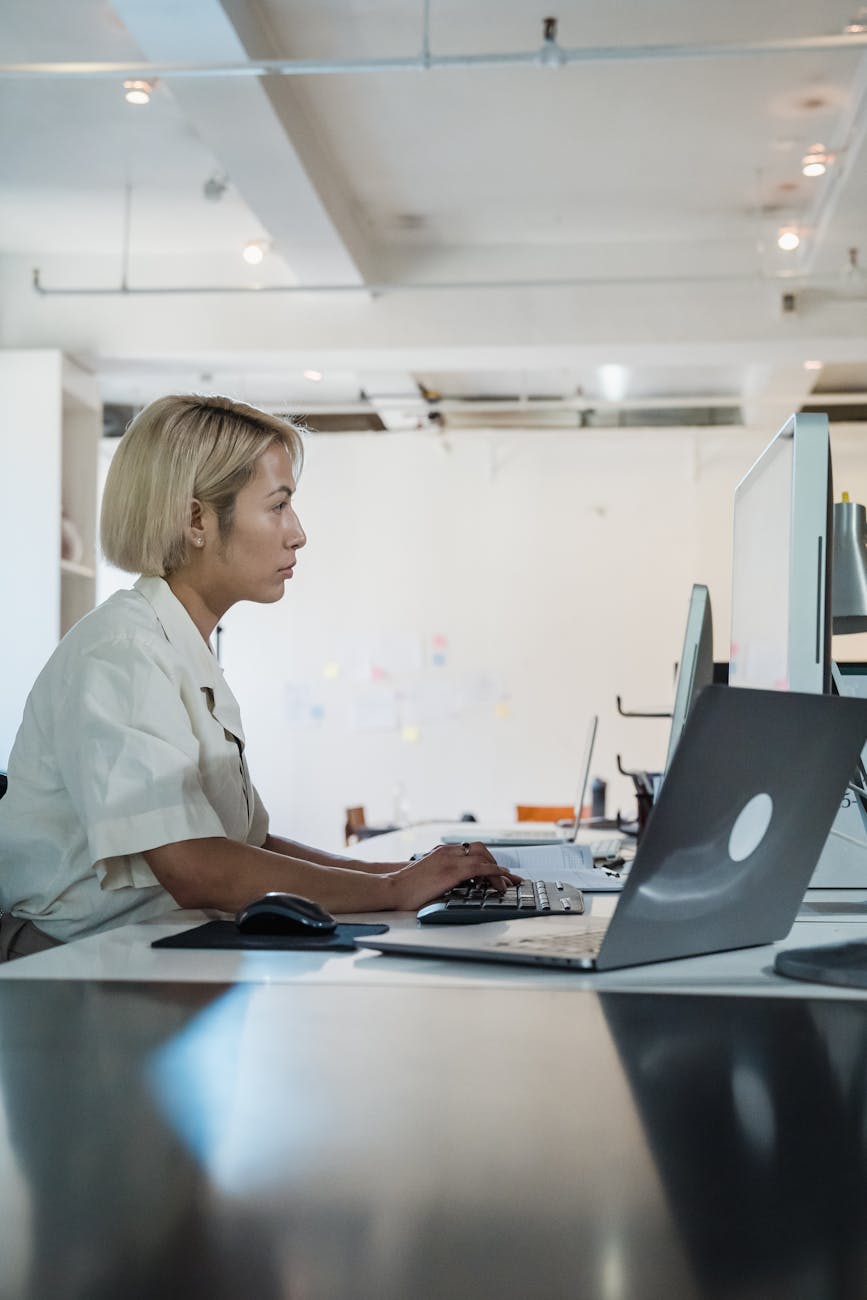 profile of a woman using computer in a white office