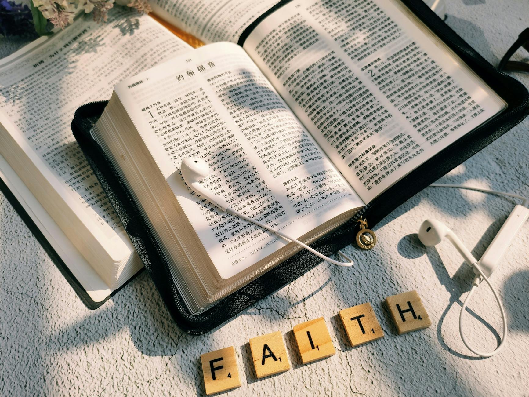top view of the bible and the word faith made from letter tiles
