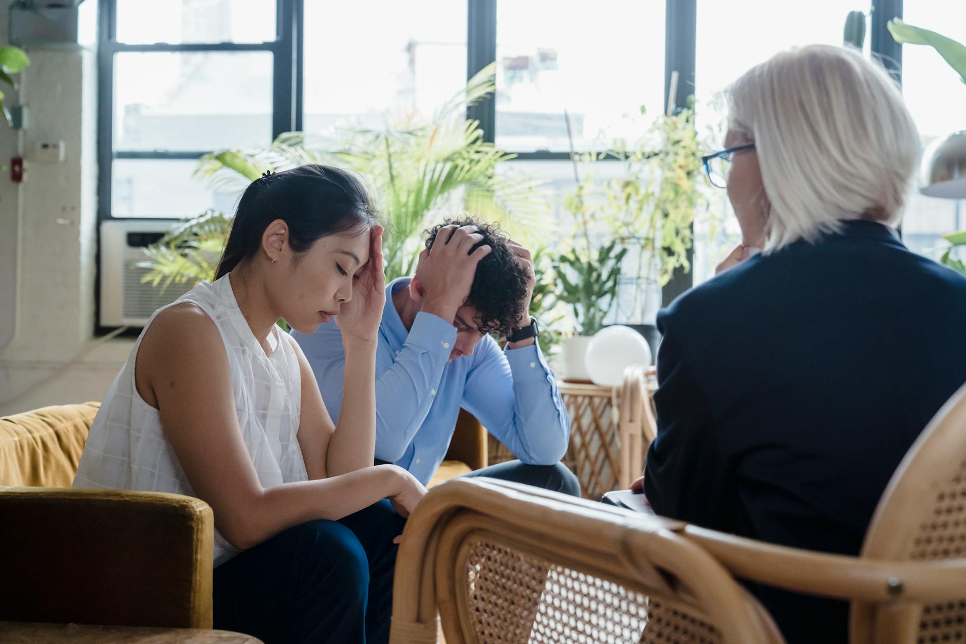 woman giving bad news to a young couple