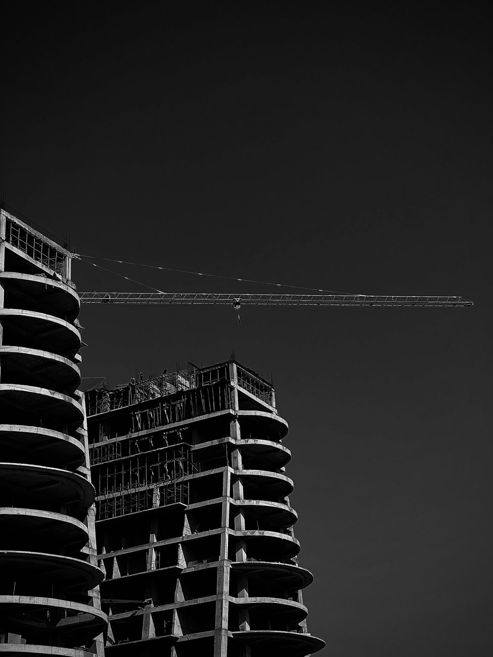 consruction crane and buildings in black and white