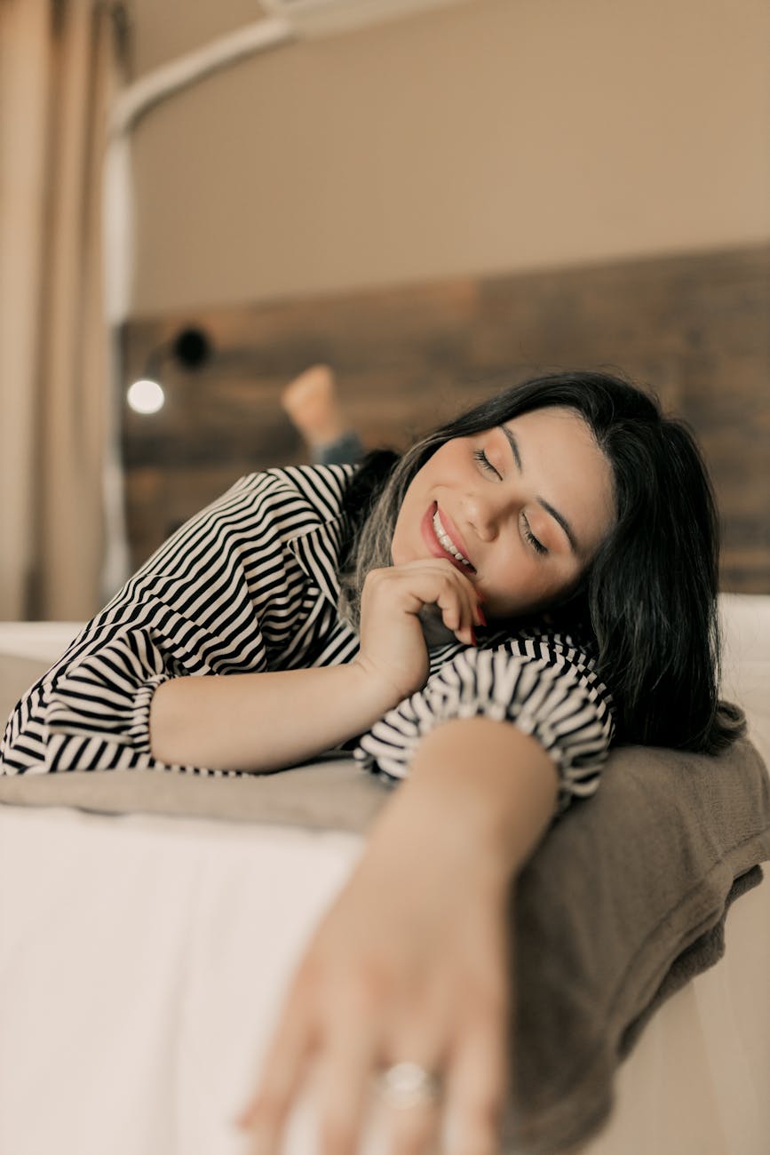 relaxed woman resting on bed at home
