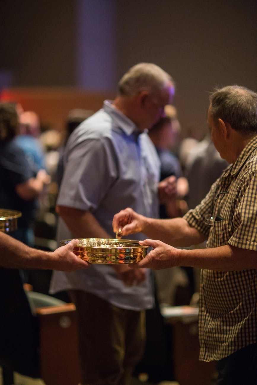 men participating in church collection ceremony