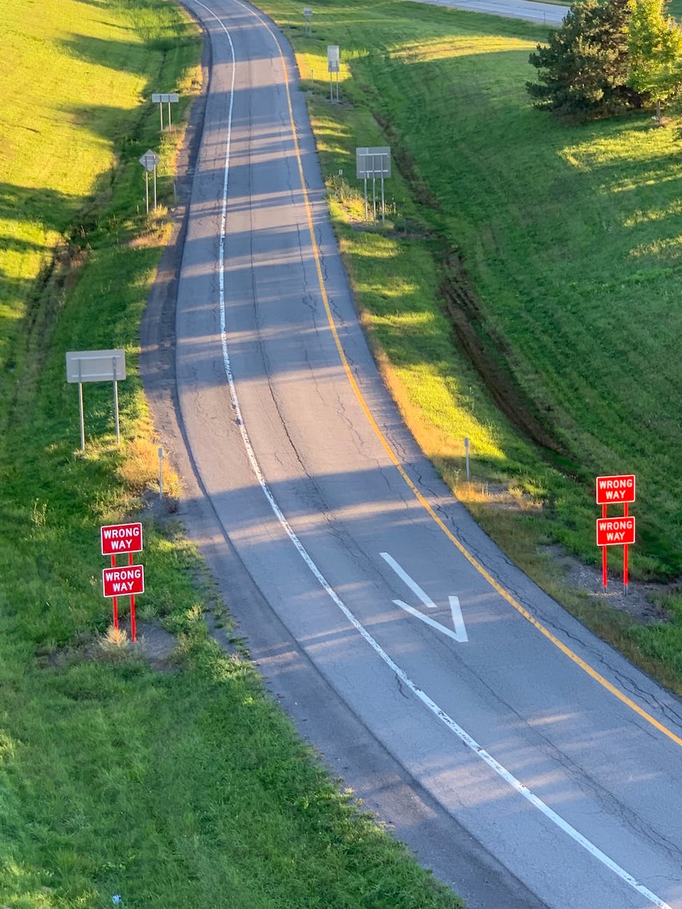 aerial view of a wrong way road sign on highway