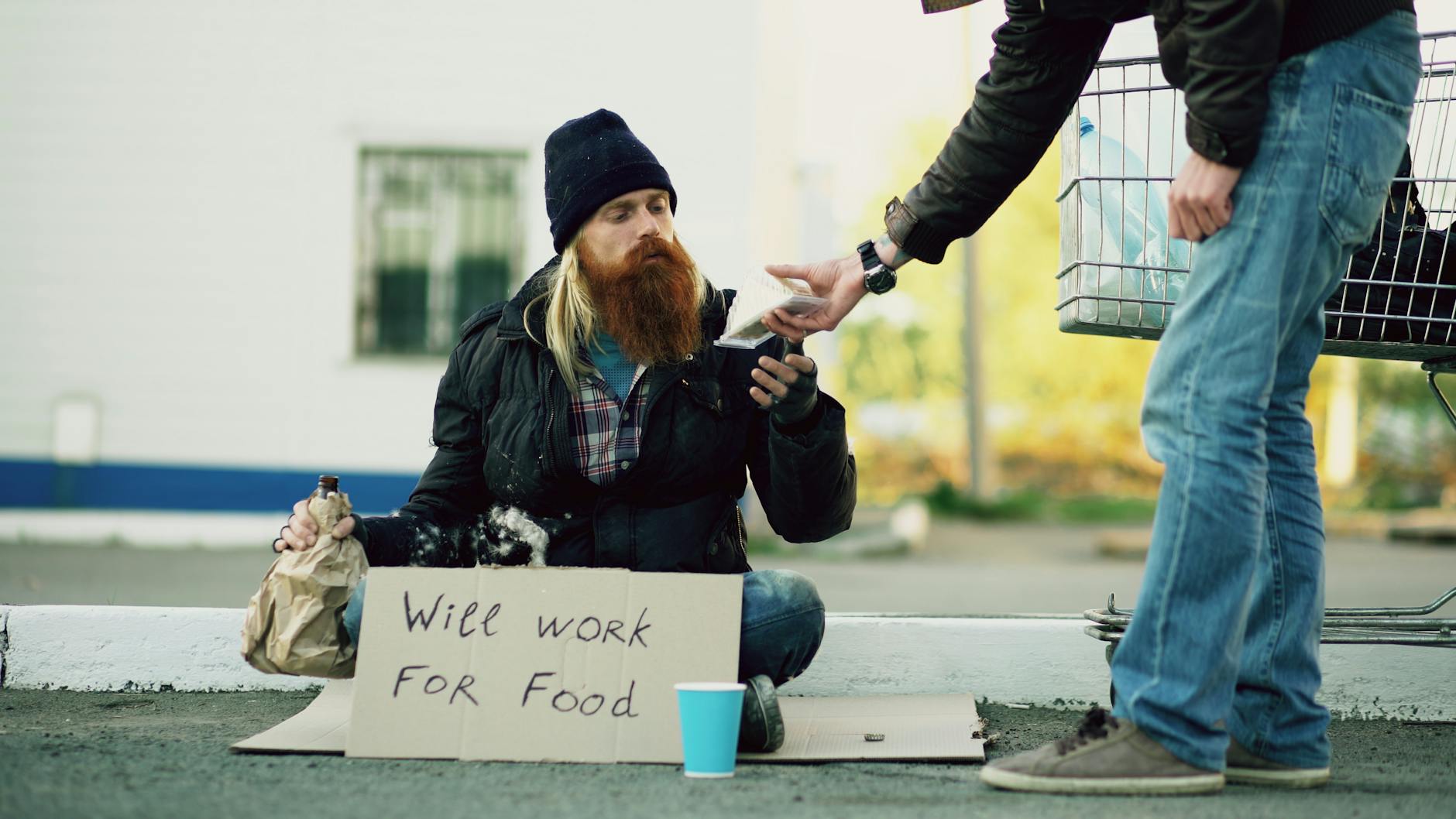 homeless person receiving help on street