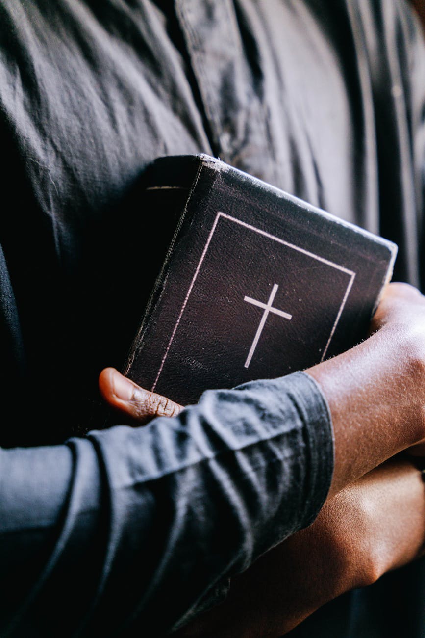 persons hugging a bible