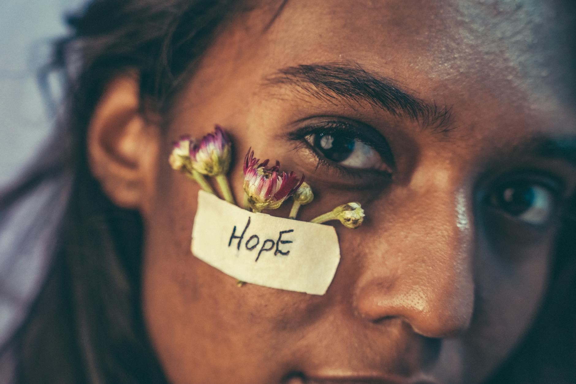 hope text on plaster and flowers on face of woman